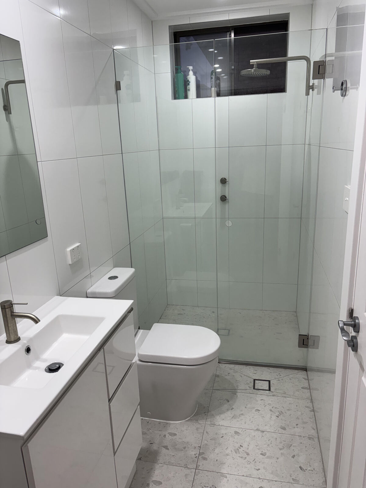 Frameless glass ensuite with vanity and toilet
